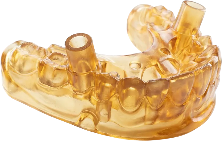 SLA teknolojisiyle biyouyumlu reçineden üretilmiş, implant cerrahisinde kullanılan şeffaf sarı cerrahi kılavuz (surgical guide).
